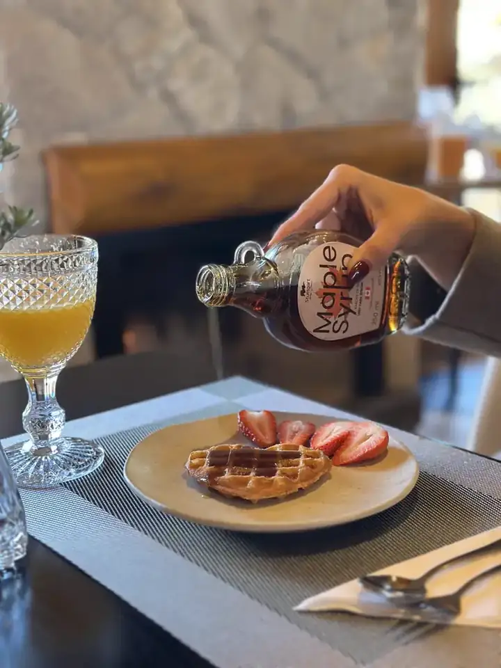 Waffle com morangos e maple syrup no café da manhã da Pousada Maple